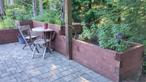A hardscaped wall and paved patio